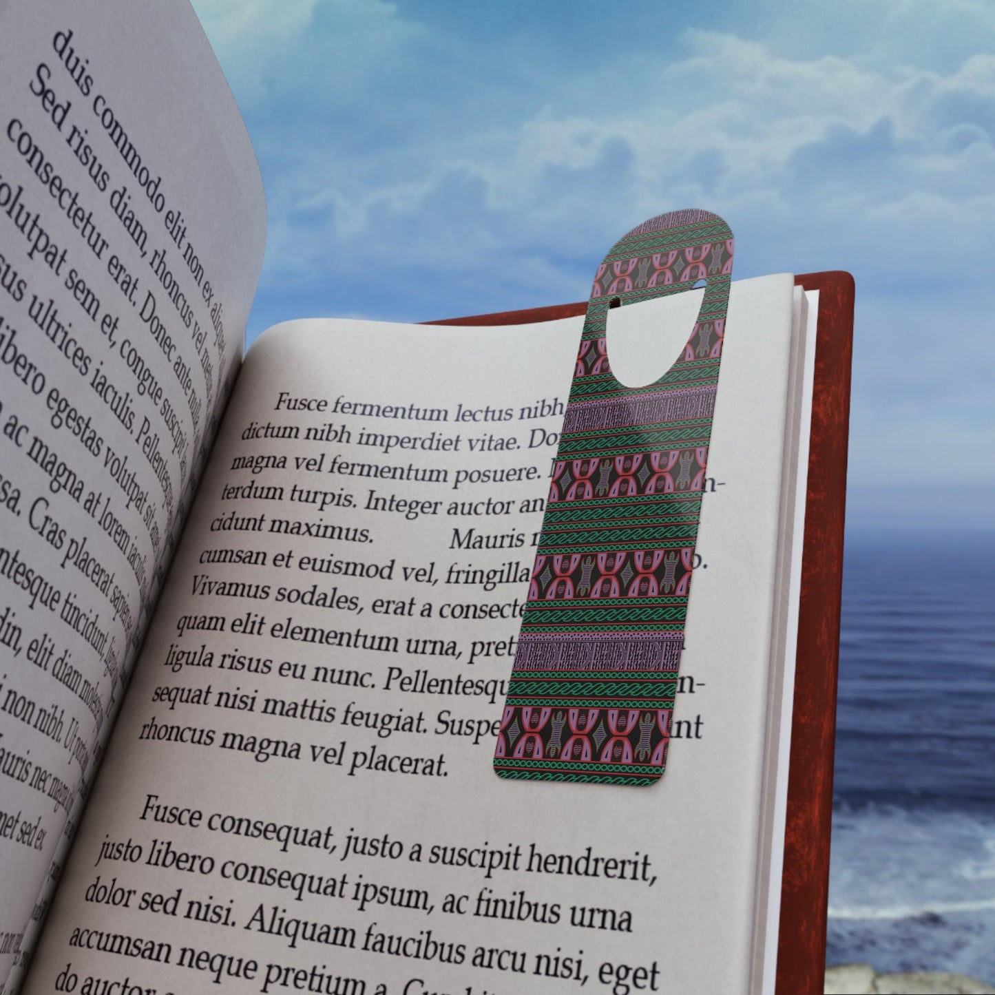 May include: A bookmark with a dark-green, purple, and pink geometric pattern. The bookmark has a hole at the top for hanging.  The text on the book page includes Latin phrases such as 'Fusce fermentum lectus nibh dictum nibh imperdiet vitae.' and 'Fusce consequat, justo a suscipit hendrerit.'