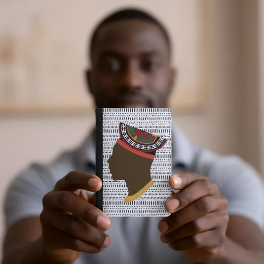 A person is holding a book with a colorful, patterned cover featuring a stylized profile of a person's head.