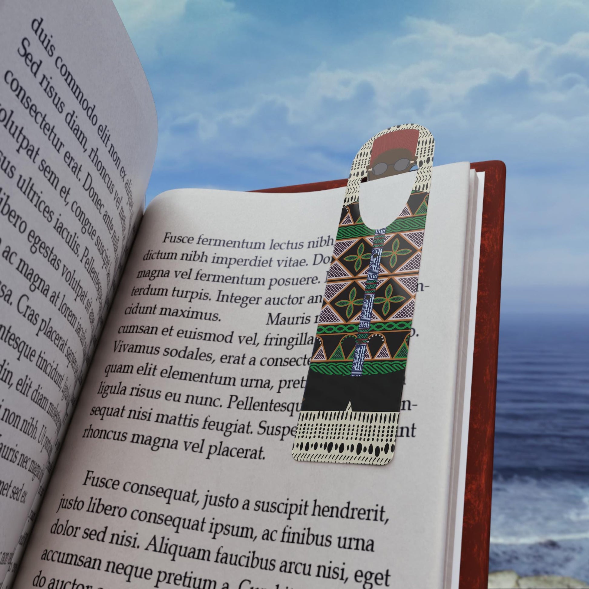 May include: A bookmark features a stylized figure in black, green, and beige patterned clothing. The figure has a red hat and glasses. The bookmark is shown inserted into a book with text visible.  The text on the bookmark is not legible. The book's text is in a serif font.