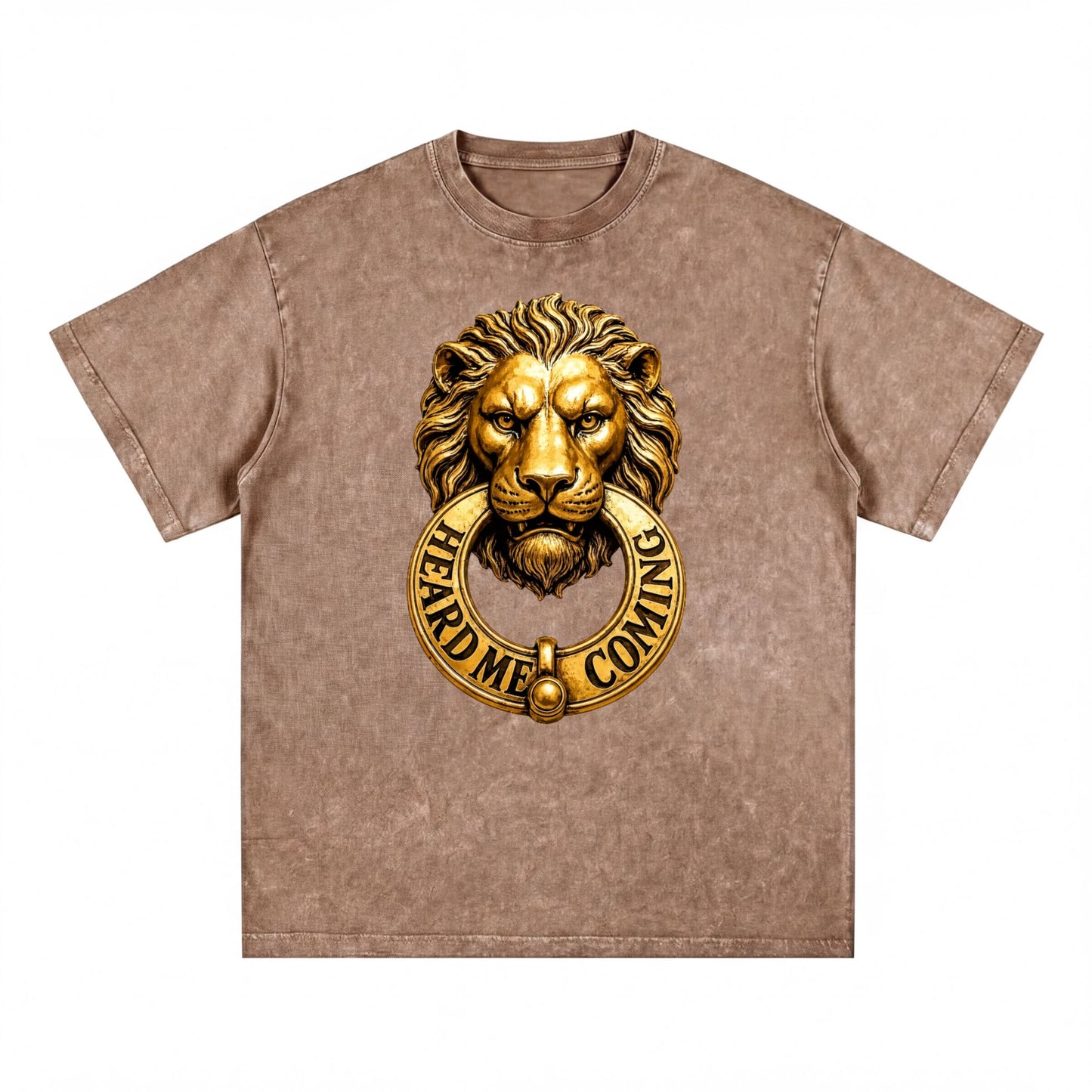 A t-shirt with a gold lion's head design and a golden ring around it, with the text "HEARD ME COMING" printed on it.