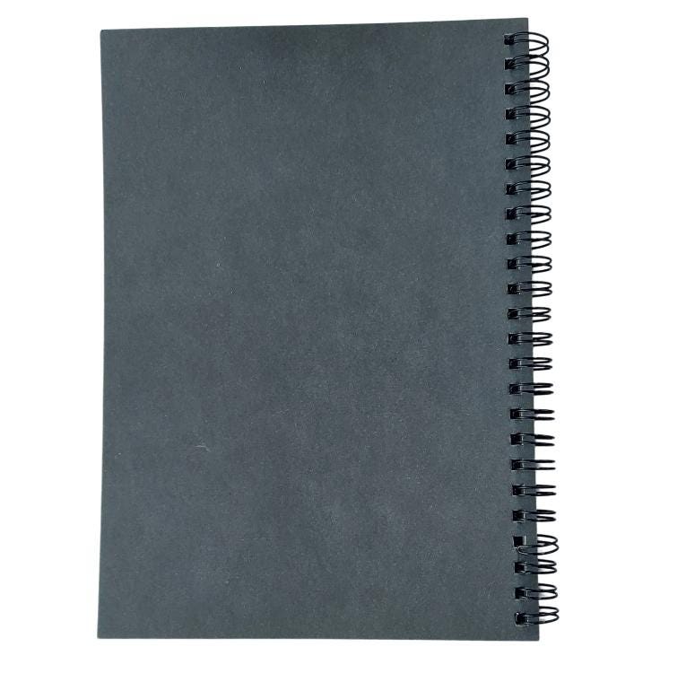 a spiral notebook with a black cover on a white background