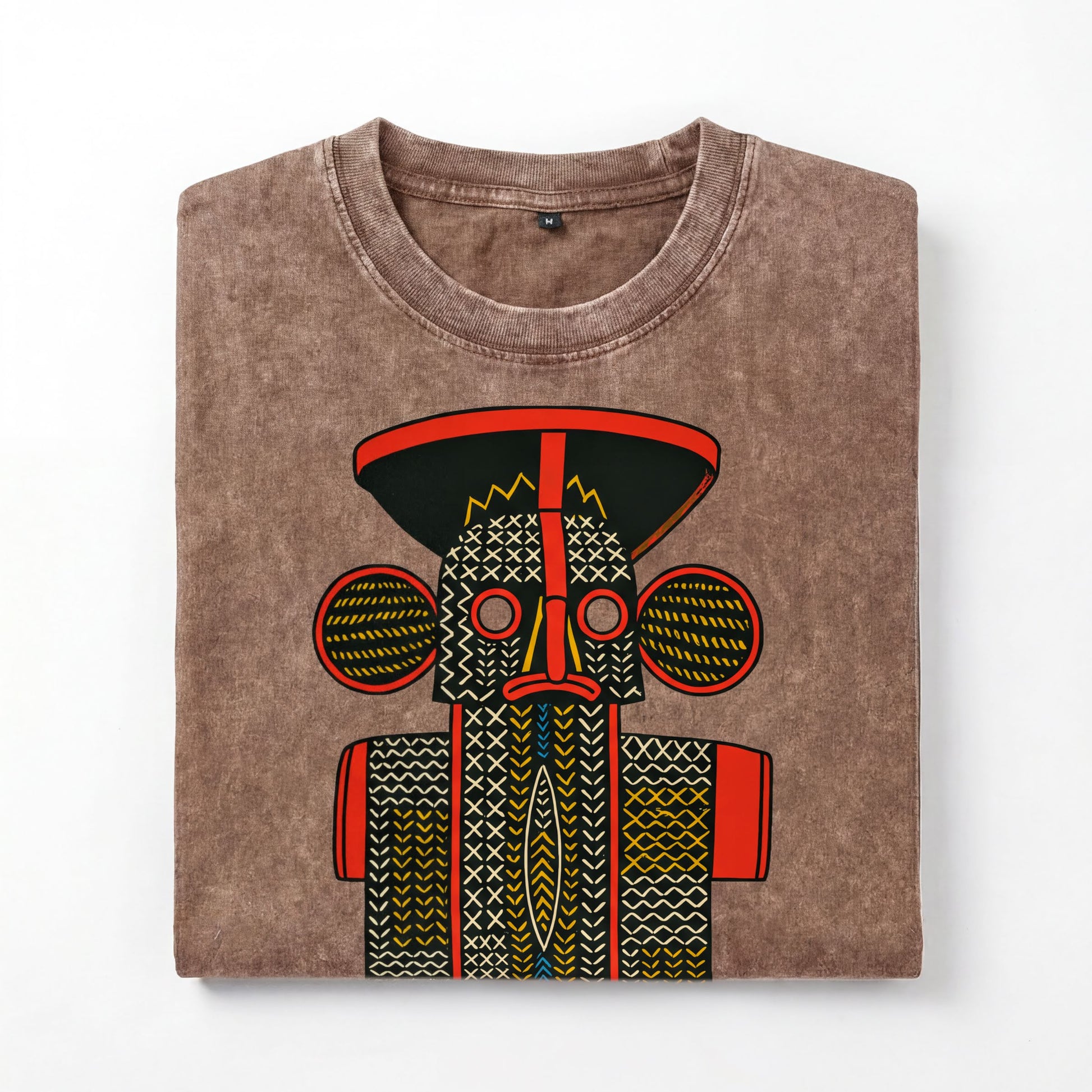 a brown t-shirt with a colorful, abstract design depicting a stylized face or mask.