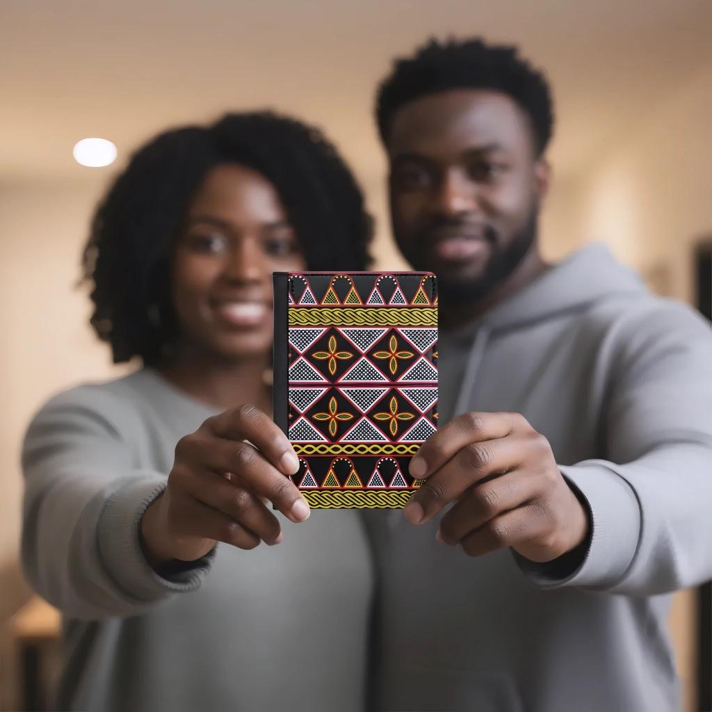 A smiling couple holding up a colorful, patterned notebook or book together.