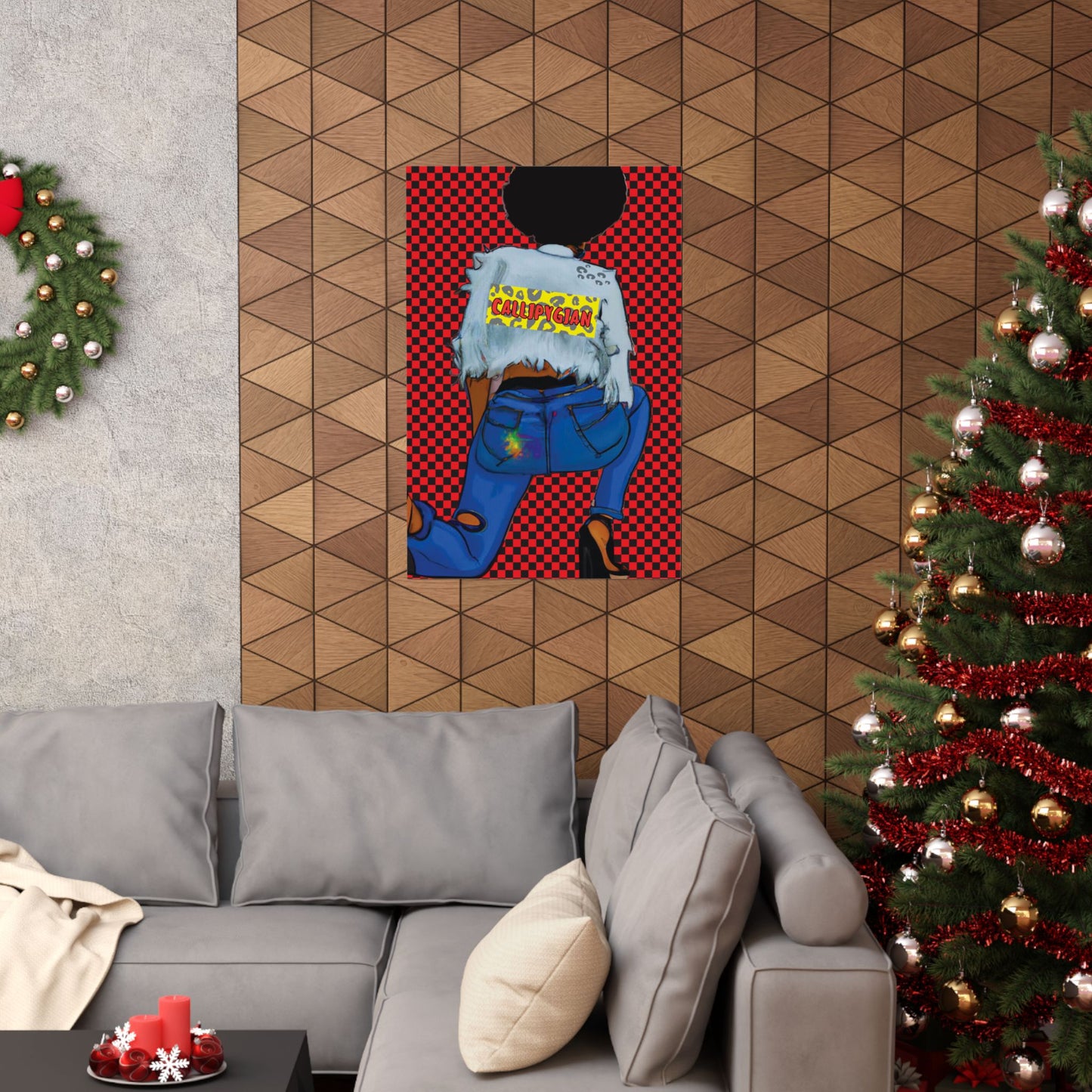 a cozy living room with a gray couch, a Christmas tree, and a colorful poster of a woman with a black top and blue jeans hanging on the wall.