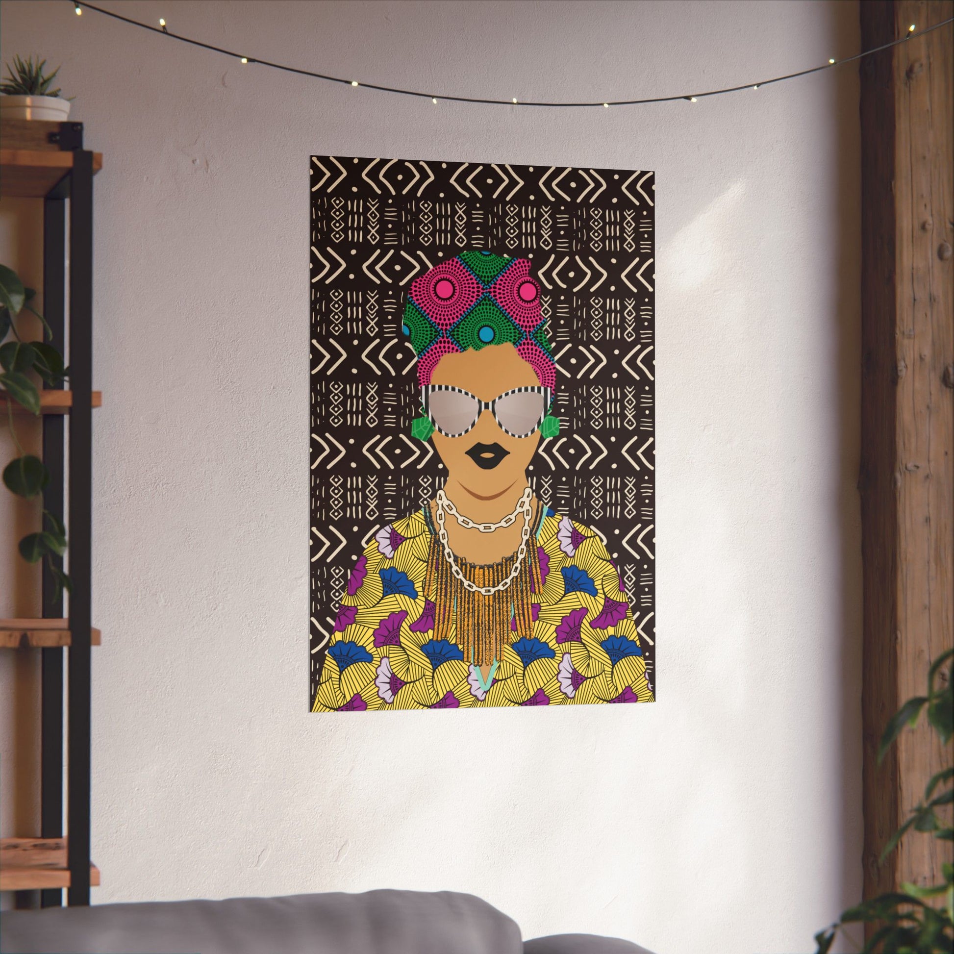 a colorful and vibrant poster of a woman with a headdress, displayed on a wall in a room with a string of lights above it.