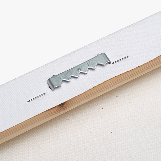 A metal bracket is attached to a wooden surface, with a piece of white fabric or material hanging from it.