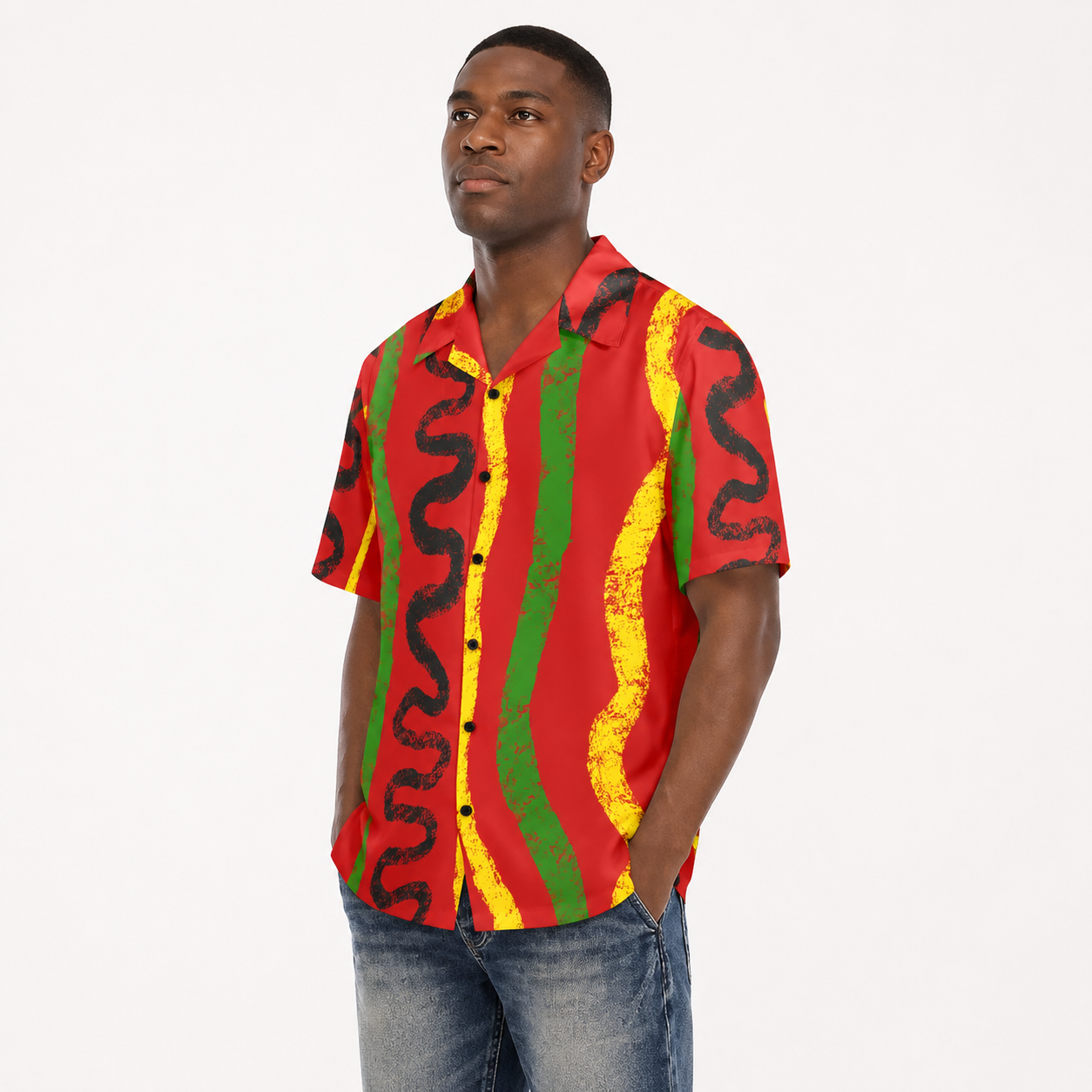 A man wearing a colorful, patterned short-sleeved shirt stands against a white background.
