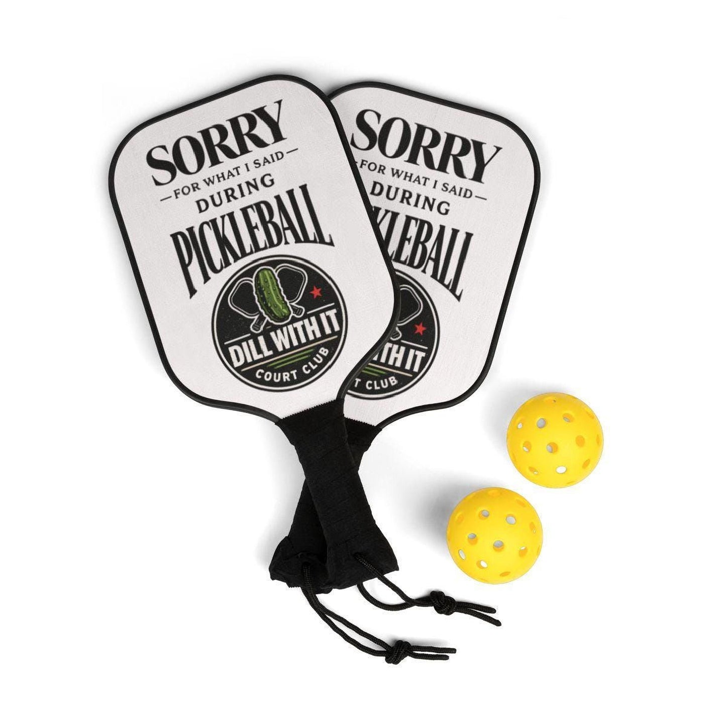 two white paddleball paddles with a humorous message printed on them, along with two yellow paddleball balls.