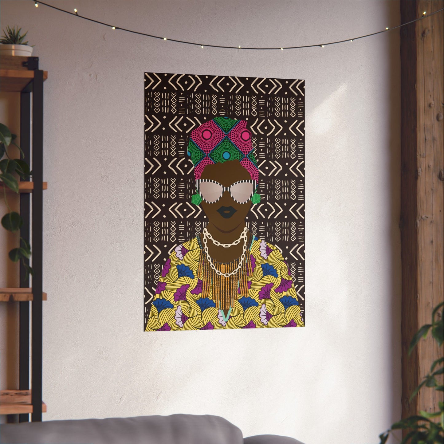 a colorful and vibrant artwork of a woman with a headdress, displayed on a wall in a room with a string of lights above it.