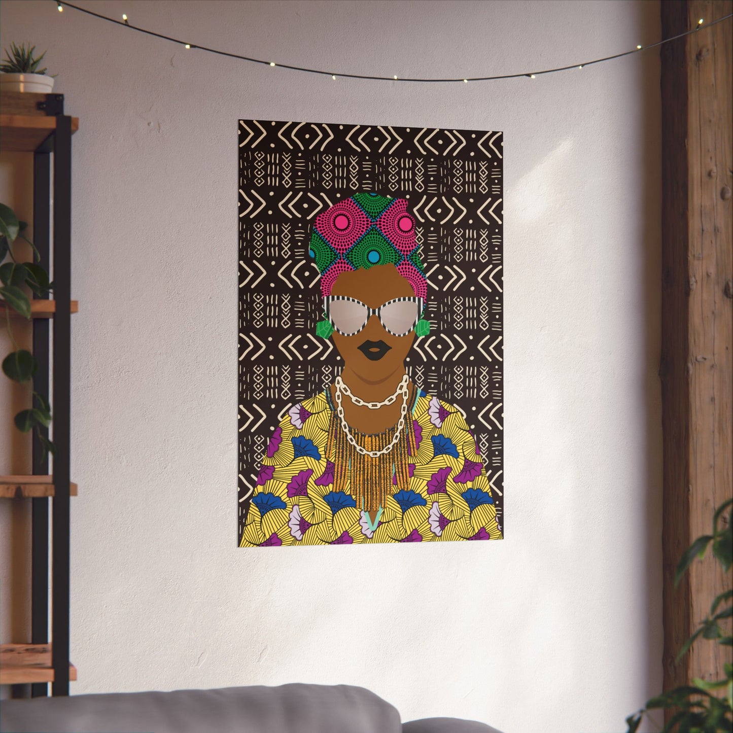 a colorful and vibrant poster of a woman with a headdress, displayed on a wall in a room with a string of lights above it.