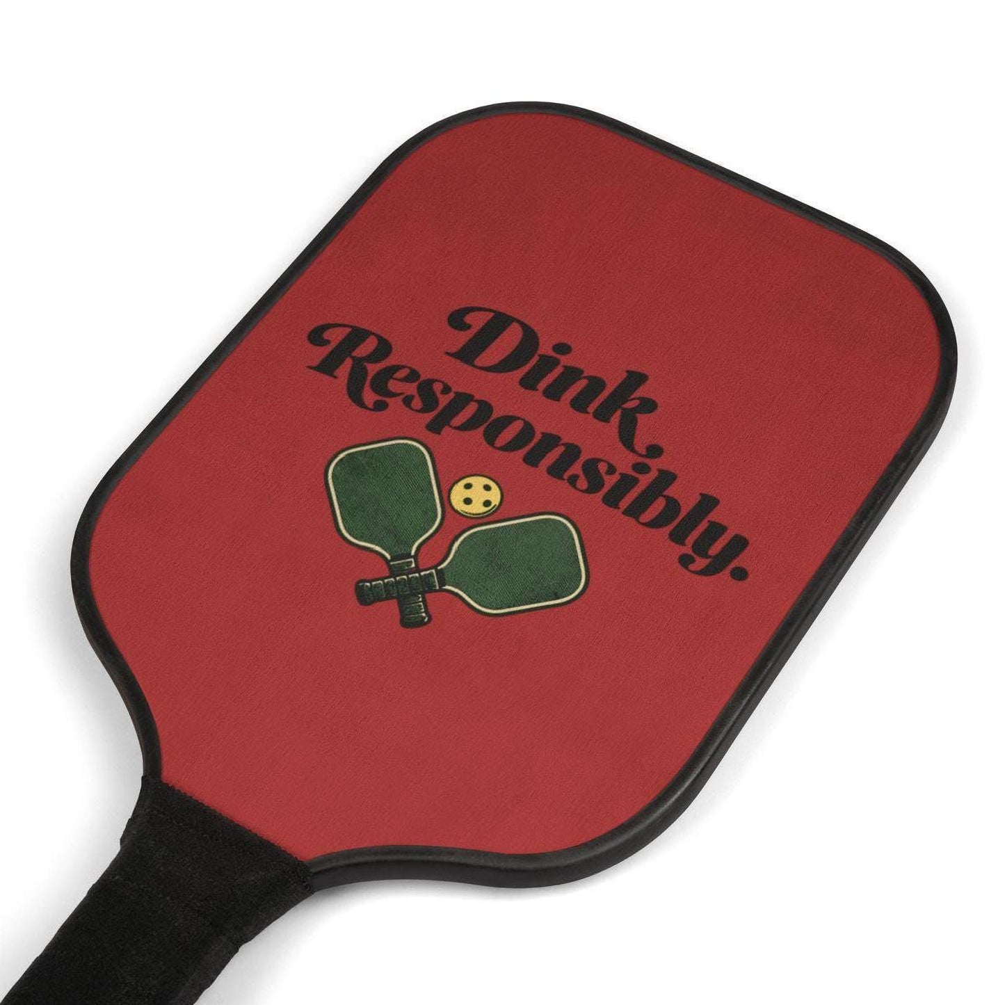 A red paddle with the text "Dink Responsibly" printed on it, along with a graphic of a green paddle and a yellow ball.