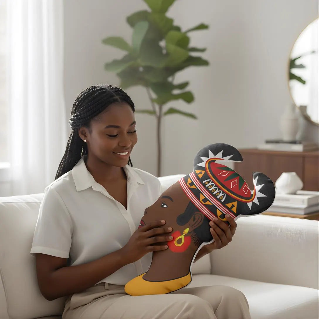 A woman sits on a couch, holding a colorful head pillow with an African-inspired design.