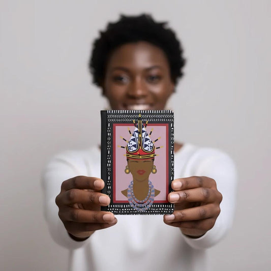 A person is holding up a framed image of a woman's face with a colorful, decorative design around it.