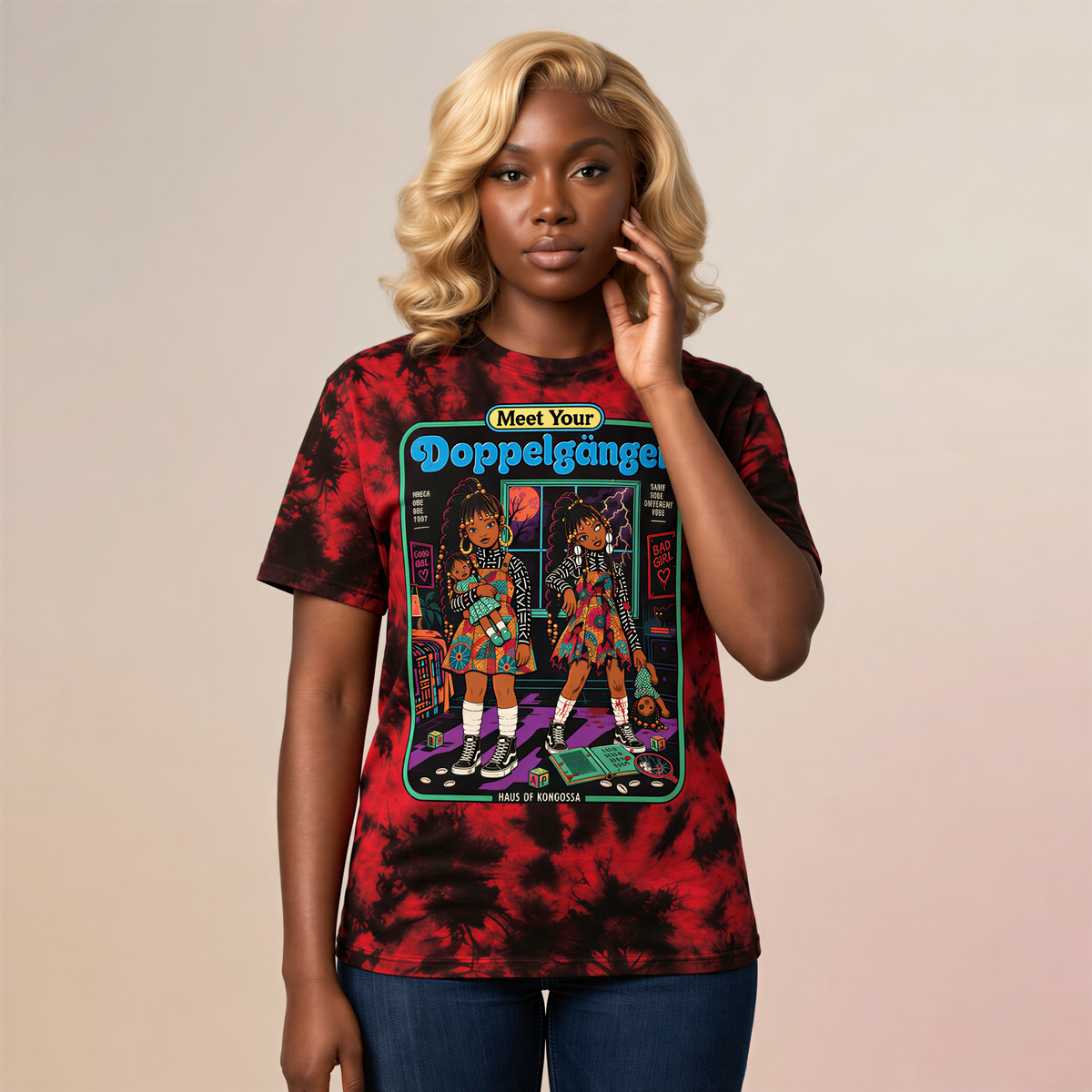 A woman with blonde hair wearing a red and black tie-dye t-shirt with a graphic design featuring two cartoon girls.