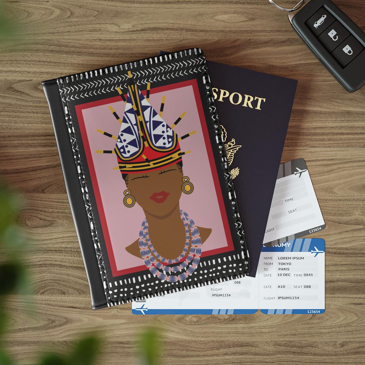 a book with a colorful illustration of a woman's face, a passport, and some travel documents on a wooden surface.