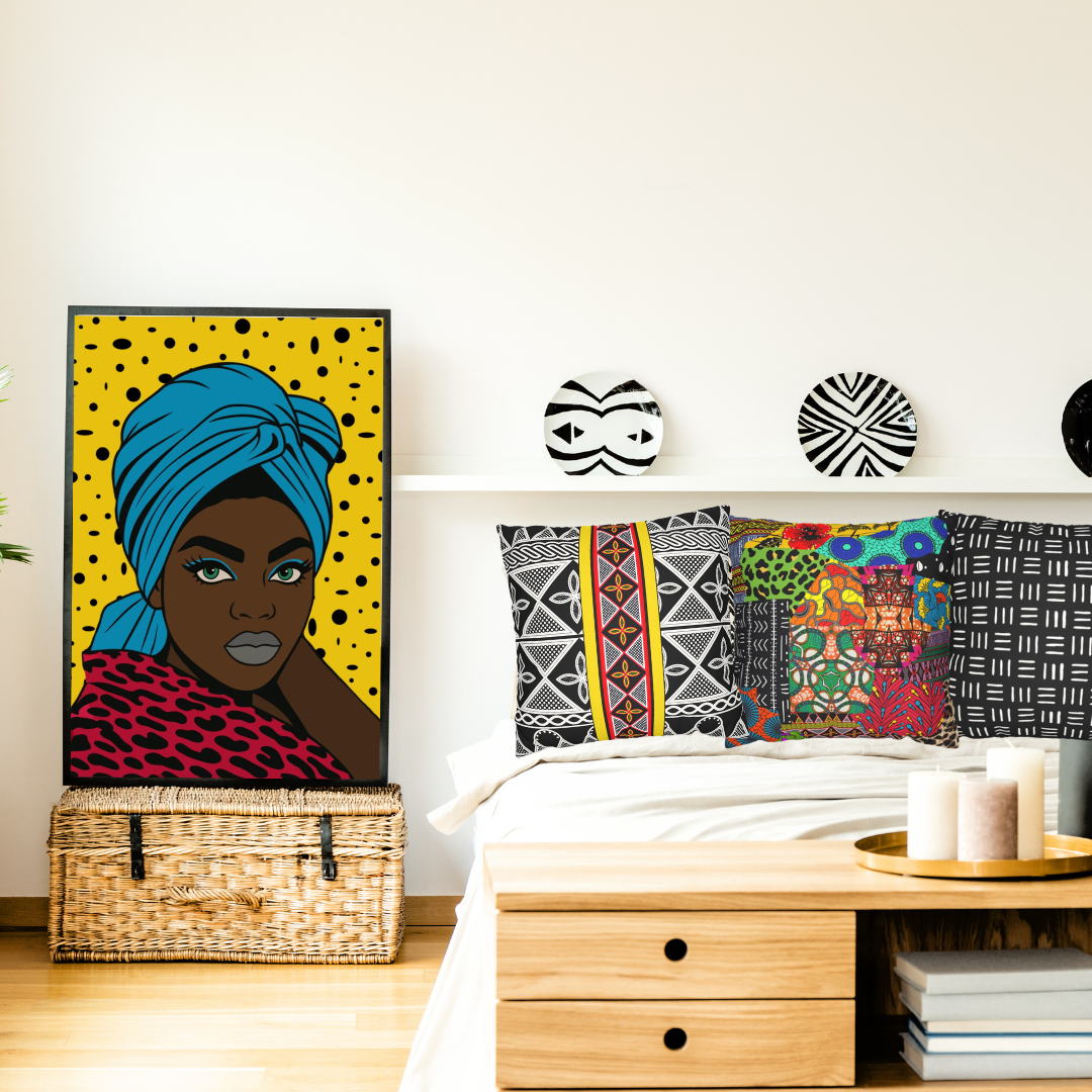 a bedroom with a bed, a wicker chest, and a wall art piece depicting a woman with a turban. The room also has decorative pillows and a wooden table with candles on it.