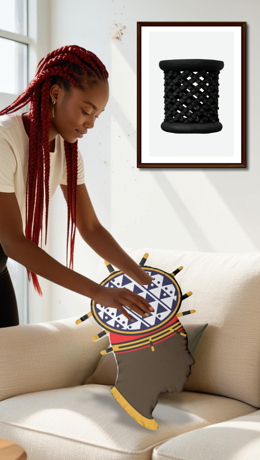 A woman with braided hair is sitting on a couch, reaching out to touch a decorative pillow with a geometric pattern.