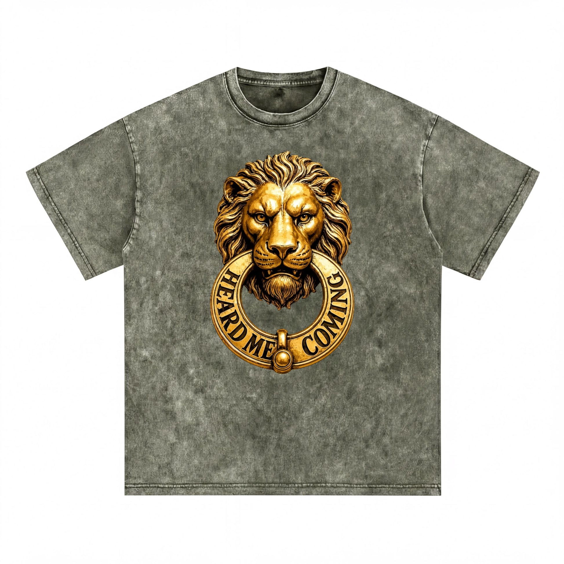 A gray t-shirt with a gold lion's head design and the text "HEARD ME COMING" printed on it.