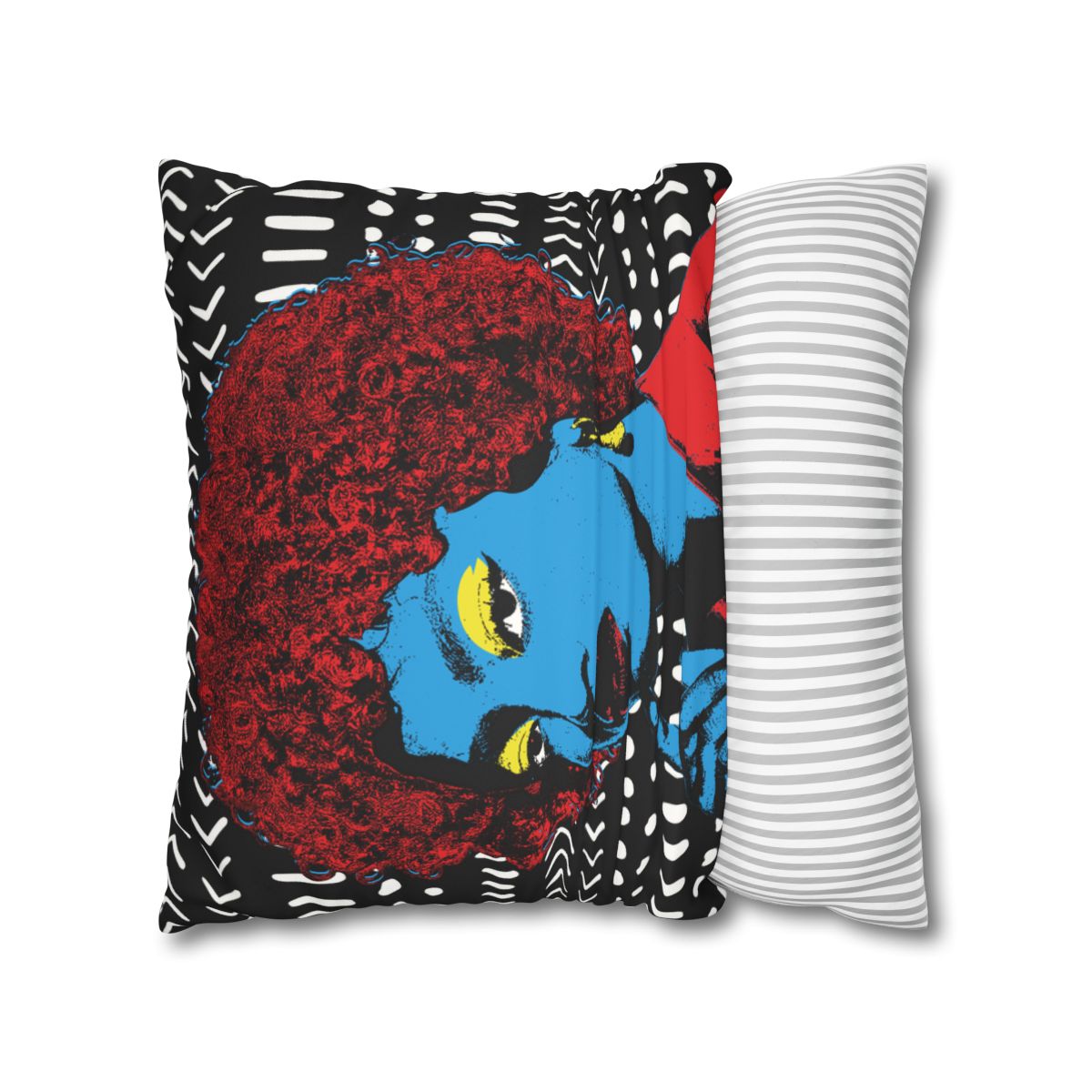 a vibrant, colorful pillow with a striking design of a woman's face. The pillow has a bold, abstract pattern with a mix of black, white, and red colors, creating a visually striking and eye-catching piece.