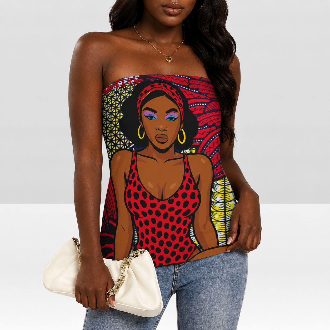A woman wearing a red and black polka dot top with a colorful graphic of a woman on it, holding a white purse.