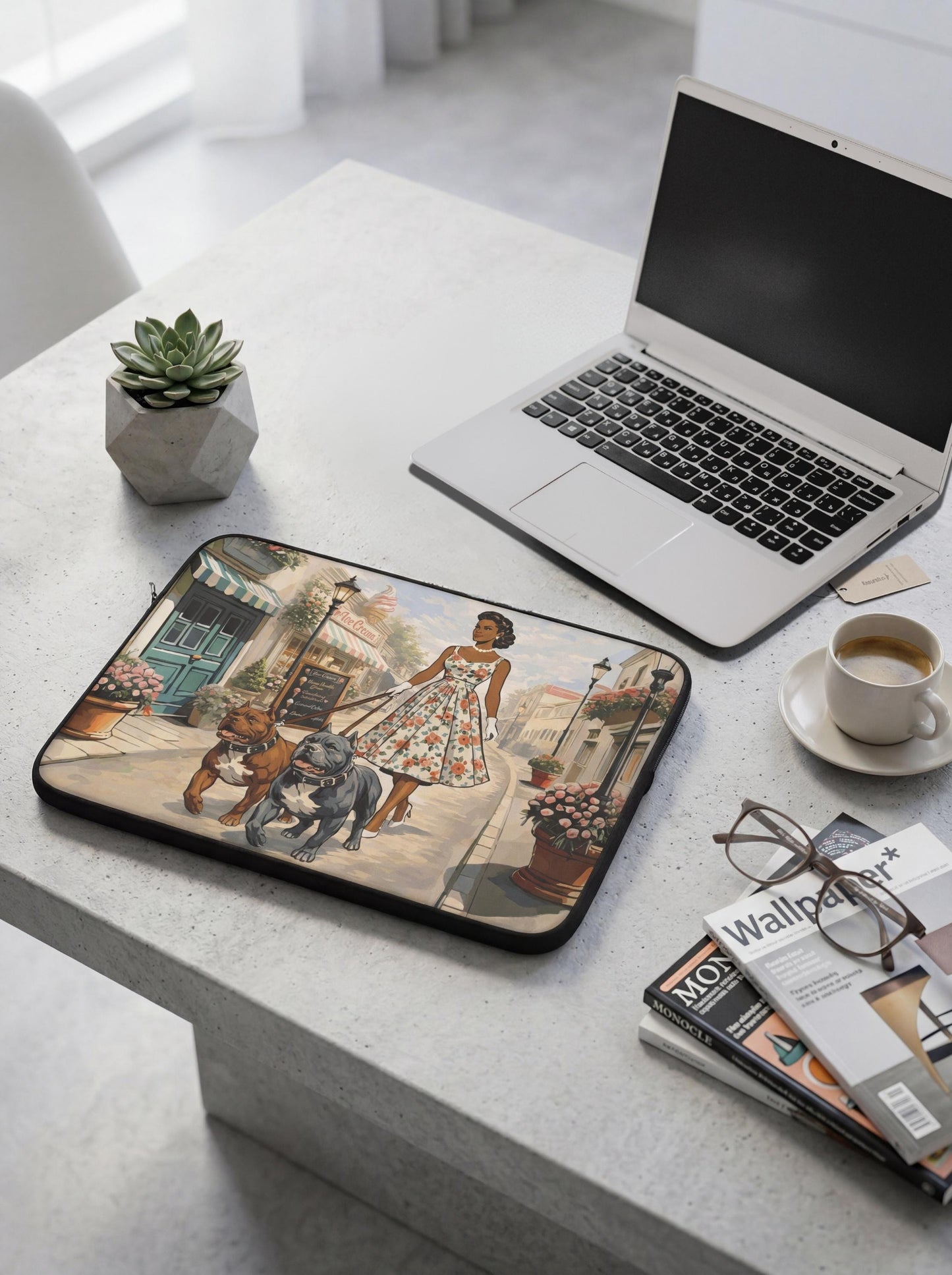 a laptop, a magazine, a potted plant, and a decorative piece on a table.