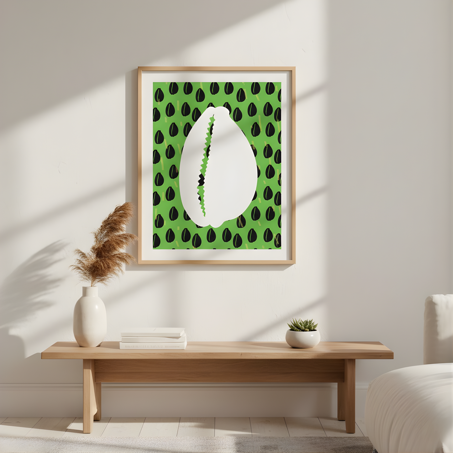a wooden table with a white vase and a stack of books on it, set against a white wall with a framed picture of a shell with green leaves hanging above it.