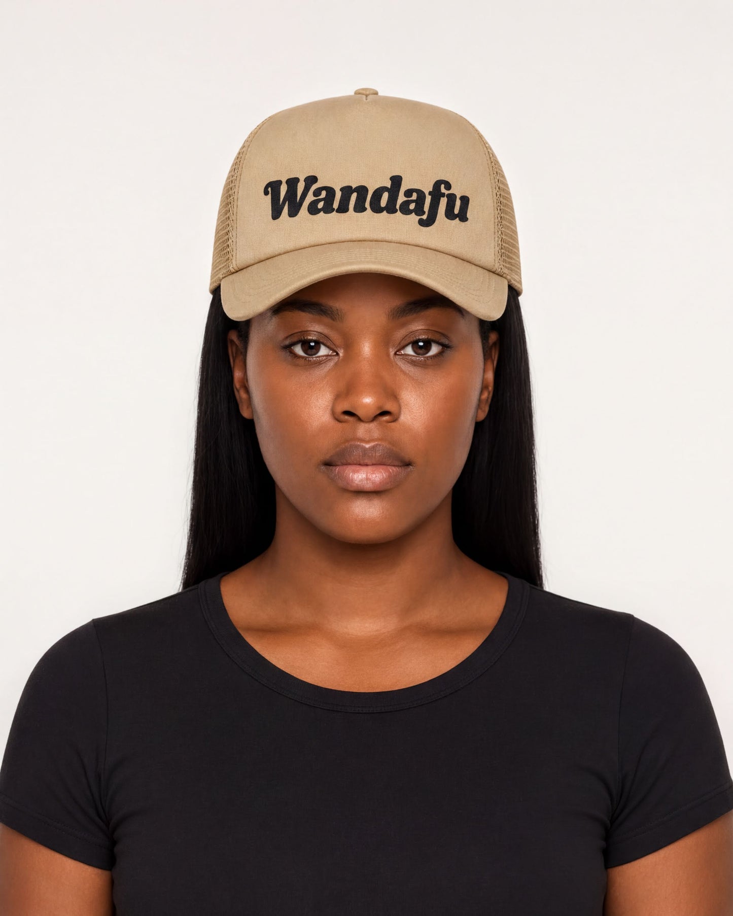 A woman wearing a tan baseball cap with the text "Wandafu" printed on it.