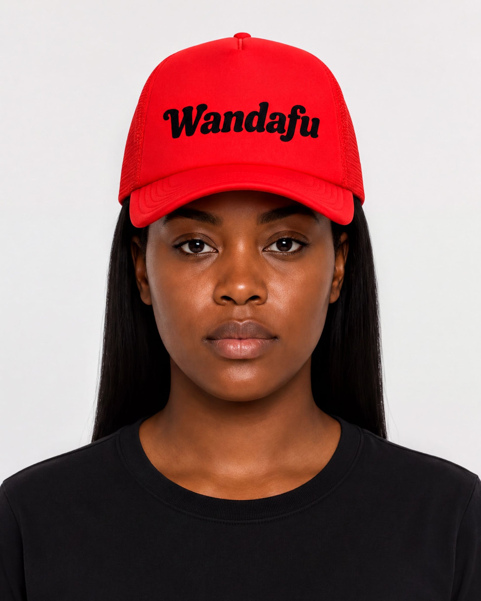 A woman wearing a red baseball cap with the text "Wandafu" printed on it.