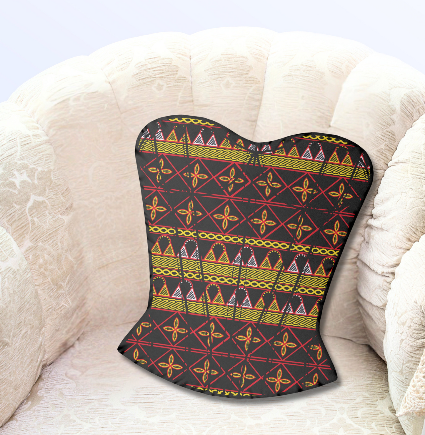 A black corset with a colorful, geometric pattern is placed on a white, curved chair.