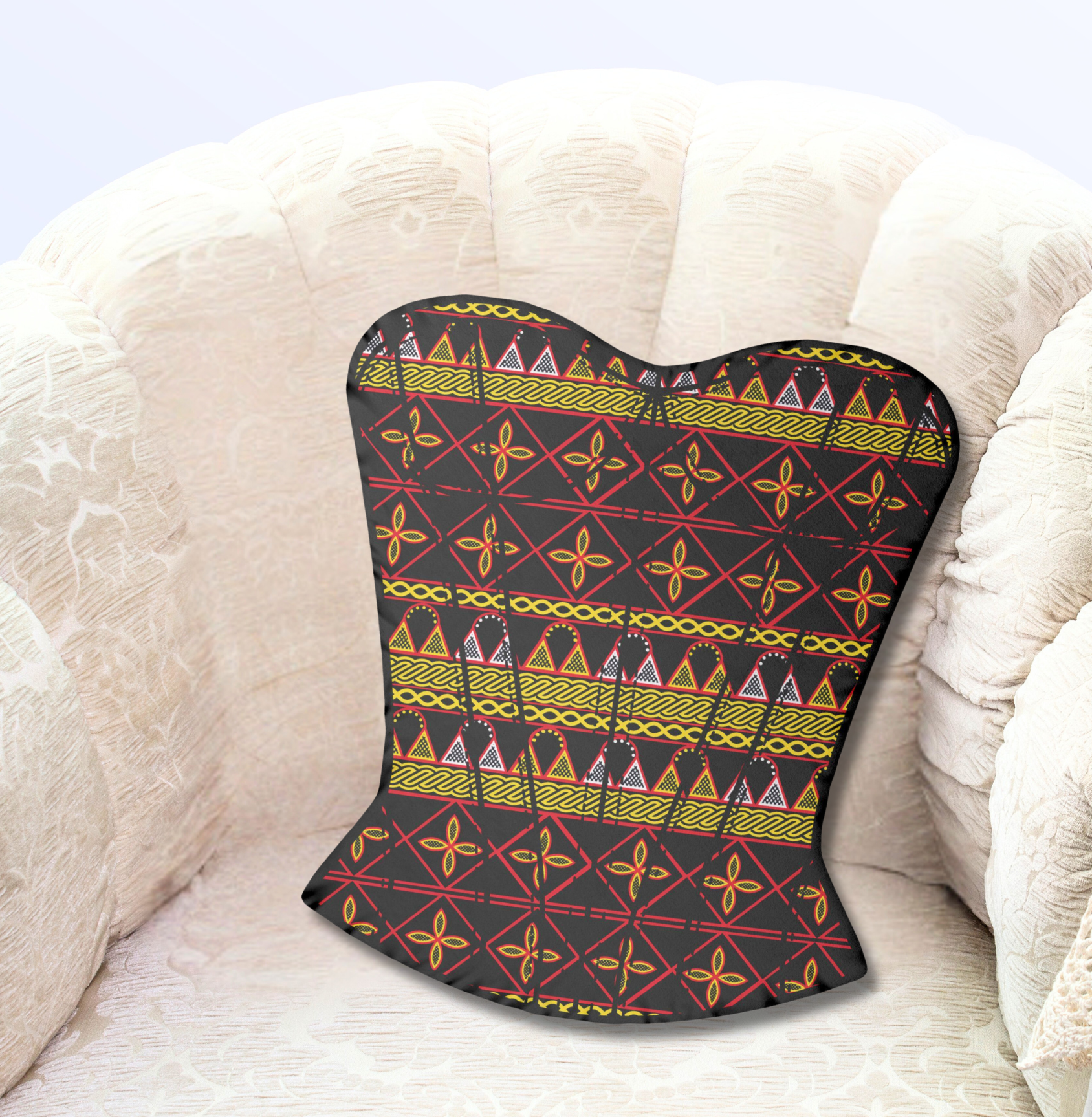 A black corset with a colorful, geometric pattern is placed on a white, curved chair.