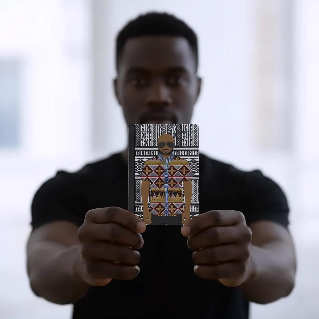 A man is holding up a notebook with a colorful, patterned design on the cover.