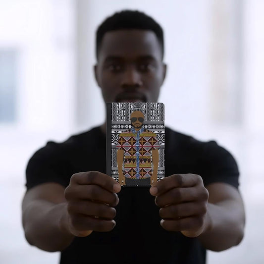 A man is holding up a notebook with a colorful, patterned design on the cover.