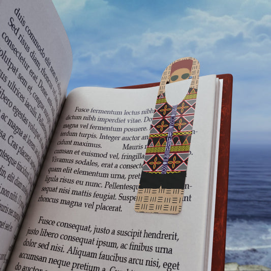 May include: A bookmark features a person wearing a patterned shirt and shorts. The shirt has geometric designs in black, beige, orange, and yellow. The shorts are black with beige stripes. The bookmark is designed to be placed in a book.  The text on the bookmark is not legible. The bookmark is shown in a book with text visible on the pages.