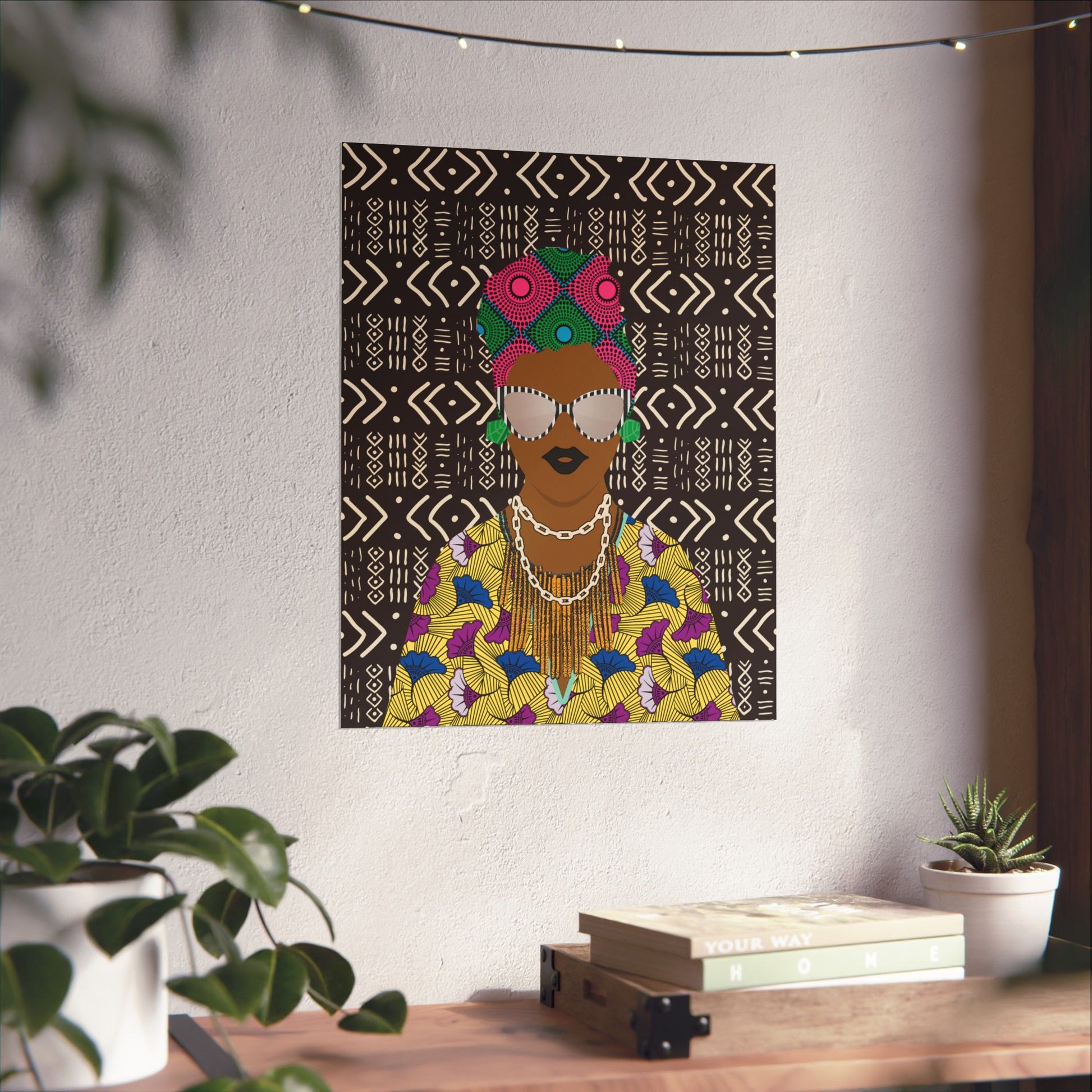a colorful, abstract portrait of a woman with a headdress, displayed on a wall above a wooden table with various decorative items.