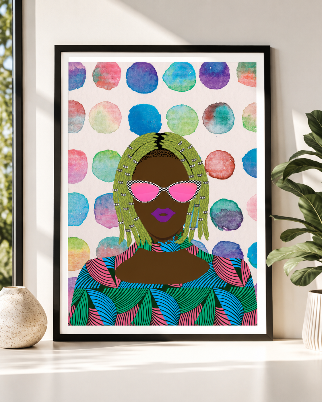 a framed artwork depicting a woman with green hair and sunglasses, wearing a colorful patterned shirt, set against a background of colorful circles.